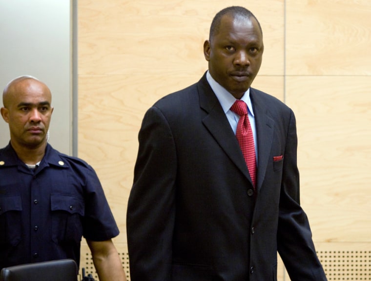 Image: Congolese militia leader Lubanga enters court at the beginning of his trial in The Hague