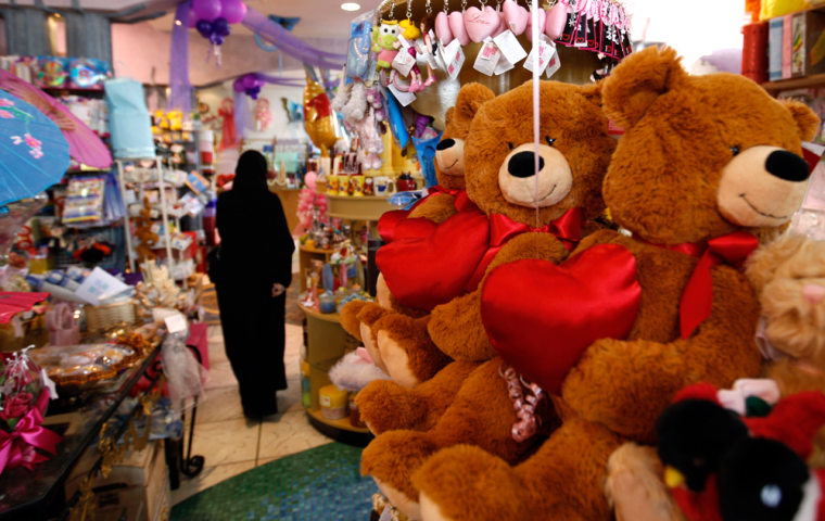 Image: A Saudi woman tries to choose a Valentine's Day teddy bears at a gift shop in the Saudi capital Riyadh, Saudi Arabia