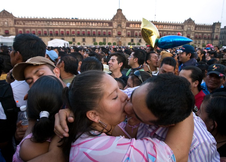 Mexican couples kiss at the Zocalo square in Mexico City, on Saturday during a Valentine's Day attempt to break the Guinness record for simultaneous kisses. They succeeded.