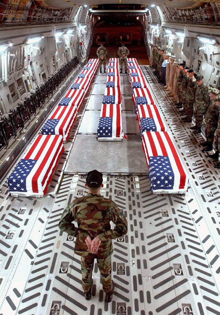 Image: Fag-draped coffins of U.S .war casualties are seen aboard a cargo plane in Dover, Delaware