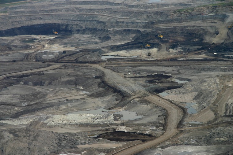 The Suncor open pit mine in Alberta, Canada, is typical of oil sands operations, where forests and topsoil are removed to reach sand that has bitumen, a kind of petroleum, mixed in it.