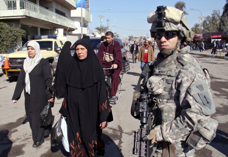 Image: A US soldier secures a street in the mainly Shiite Muslim Kadhimiya District of Baghdad.