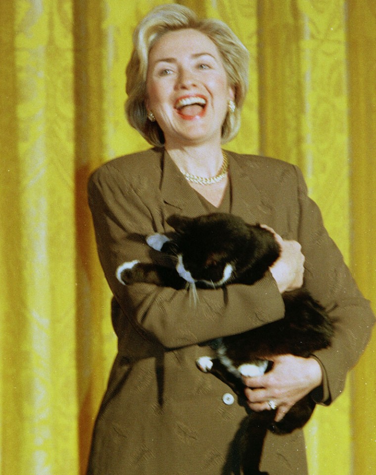 First lady Hillary Rodham Clinton sheilds First Cat \"Socks\"