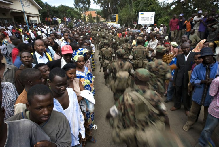 Image: Rwandan soldiers march past a crowd