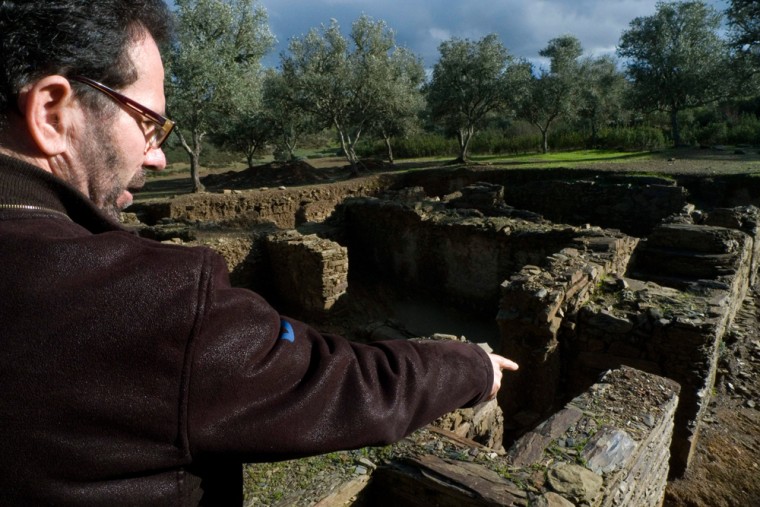 Amilcar Guerra, a University of Lisbon lecturer, shows on Feb. 5, 2009 where his team found a stone tablet with symbols at least 2,500 years old while working at the Roman ruins outside Almodovar, southern Portugal. The tablet, features 86 characters that provide the longest running text of the Iron Age extinct Iberian language called Southwest Script. (AP Photo/Armando Franca)