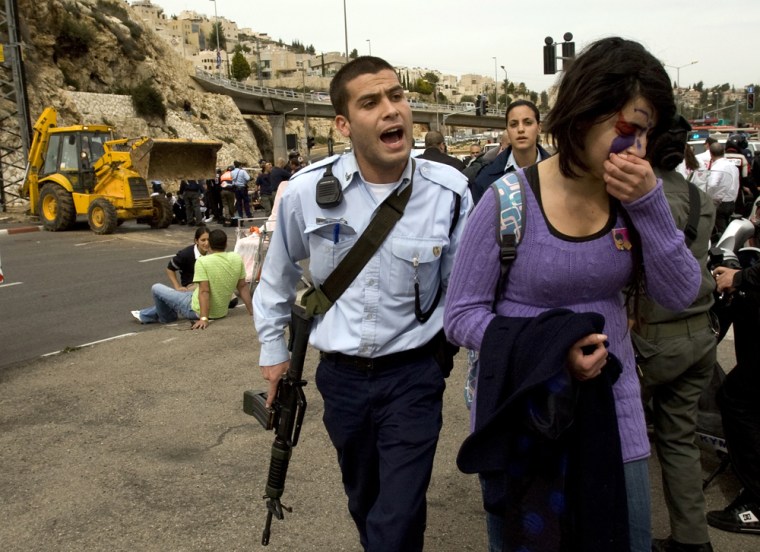 Image: Israeli police officer escorts a wounded girl in Jerusalem
