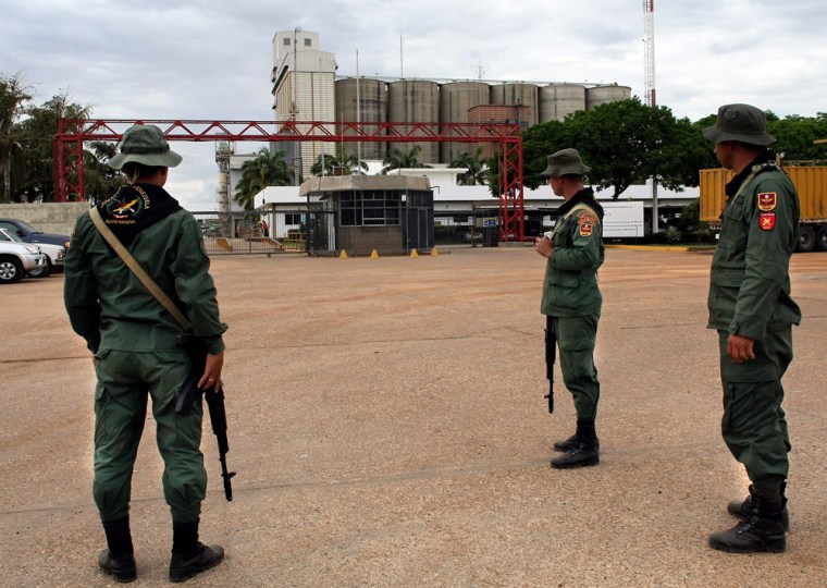 Image: Venezuelan soldiers guard the main entrance of the private plant of Polar industries