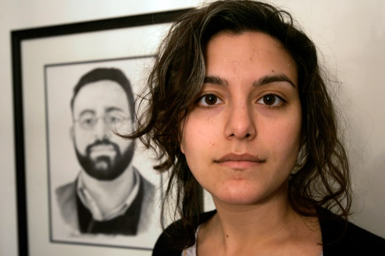 ** ADVANCE FOR MONDAY, MARCH 9 ** Tricia Bhatia, of Medway, Mass., stands in front of a drawing of her brother Michael Bhatia at the family home, in Medway, Thursday, Dec. 4, 2008. Michael Bhatia, an academic, was killed in the area of Khost, Afghanistan, in May of 2008 while working for the Human Terrain System program.  (AP Photo/Steven Senne)