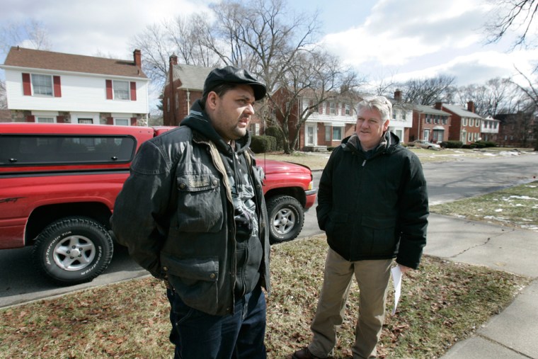 Investor Darren Veness of England, left, talks with real estate agent Jim Taylor as he looks over a house exterior in Detroit, Friday, Feb. 20, 2009.  Welcome to Landlord Nation, where foreclosure notices are plentiful and for-sale signs offer at least 1,800 homes for under $10,000 that once were worth at least 10 times more. In extreme cases, homes are on sale for $1 or less, which has enticed investors to Detroit from as far away as the United Kingdom and Australia.  (AP Photo/Carlos Osorio)