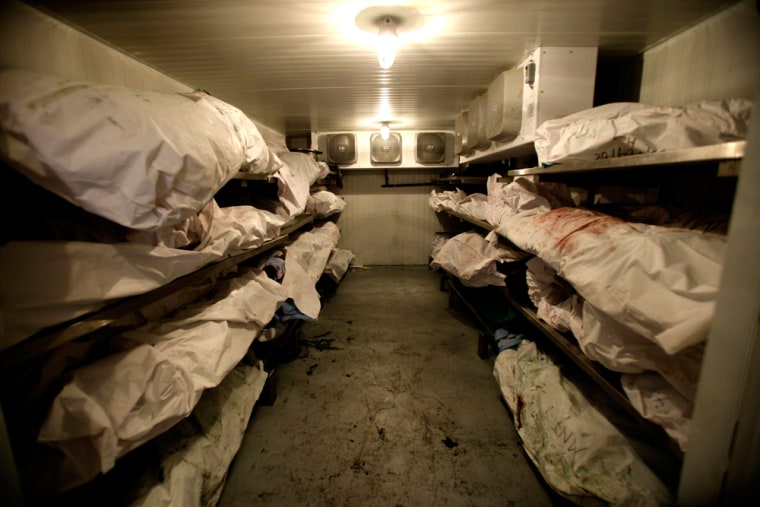 Bodies awaiting autopsies crowd a walk-in refrigerator at the morgue in the border city of Ciudad Juarez, Mexico. 