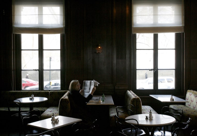 Image: A customer reads the paper at the Austrian-style Cafe Sabarsky in New York
