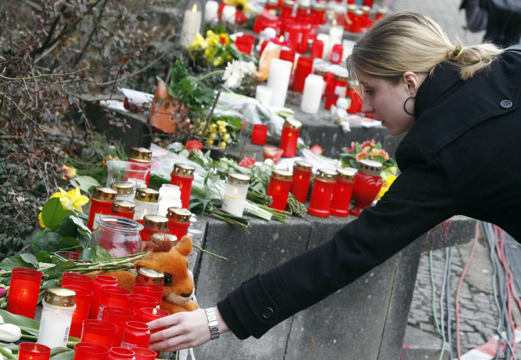 Image: Student lights a candle at the Albertville-Realschule school where a shooting incident took place in Winnenden