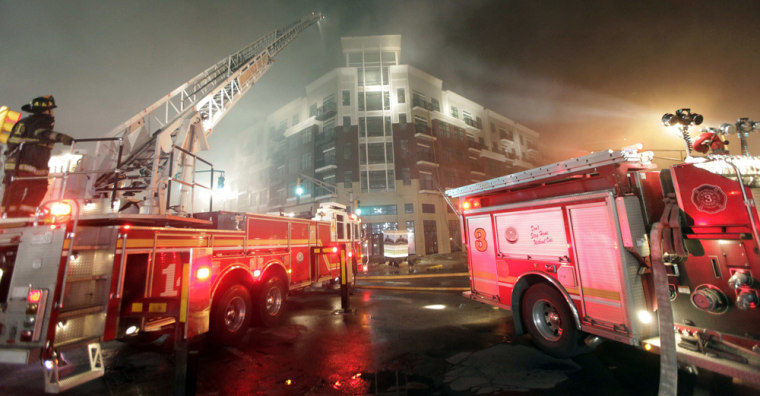 Image: Firefighters work on extinguishing a fire at a downtown condo development in Indianapolis