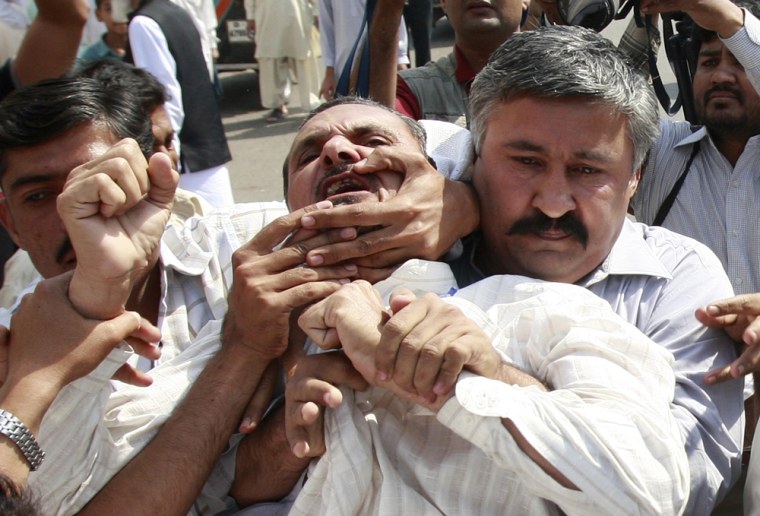 Image: Pakistani plainclothes policemen drag and arrest a political party activist