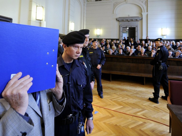 Image: Defendent Josef Fritzl hides his face at his trial in Austria