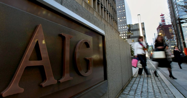 Image: Women walk in front of the AIG building in Tokyo
