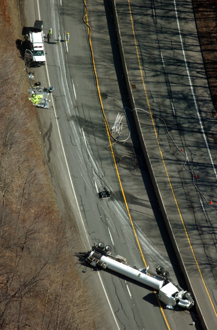 A tractor trailer carrying hydrofluoric acid sits on its side on Route 33 south near Wind Gap, Pa., on Saturday. Authorities ordered some 5,000 people in and around a northeastern Pennsylvania town to evacuate.