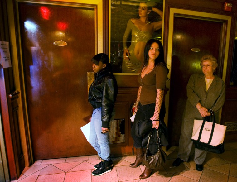 Karen Bradner waits with other job seekers to be interviewed at a job fair at the Foxy Lady Gentleman's Club in Providence