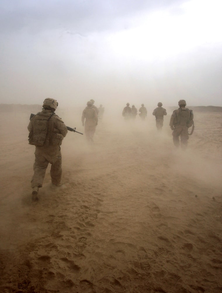 Image: U.S. Marines patrol through a sand storm in southwest Afghanistan
