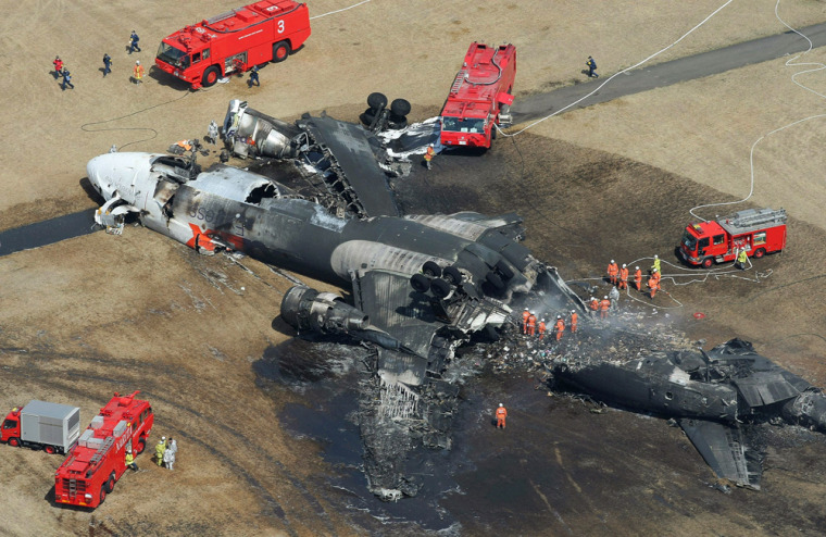 Image: Aerial shot shows a burnt out FedEx cargo plane after it crash-landed on the runway of the Narita International Airport