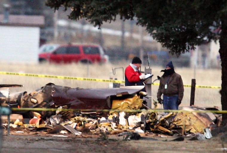 Image: Officials investigate the scene of fatal plane crash outside the Butte Airport