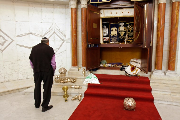 Image: A member of the Jewish community looks at a vandalized tabernacle in Caracas, Venezuela.