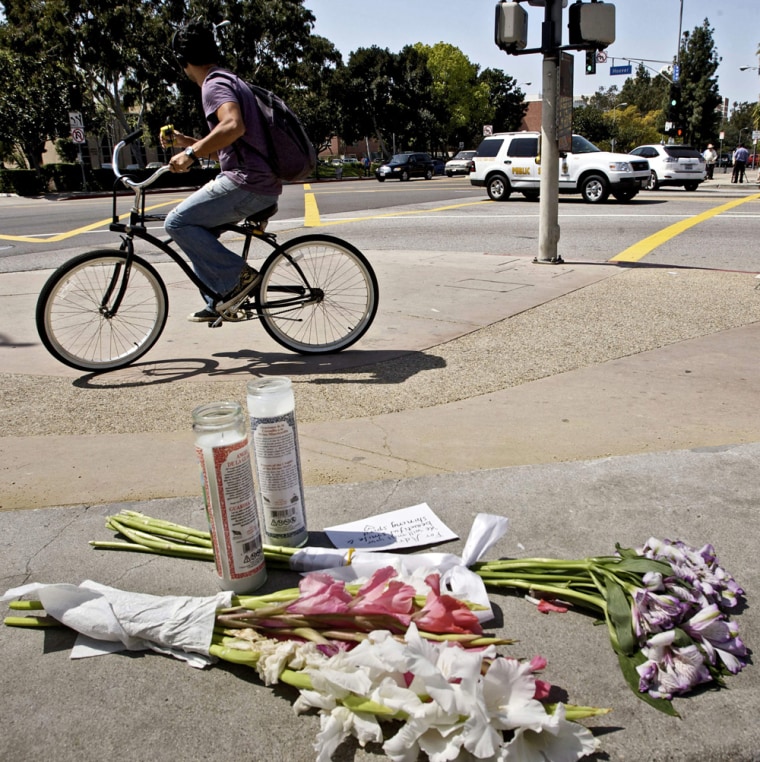 Image: Flowers are left near the spot where a driver hit two USC freshmen