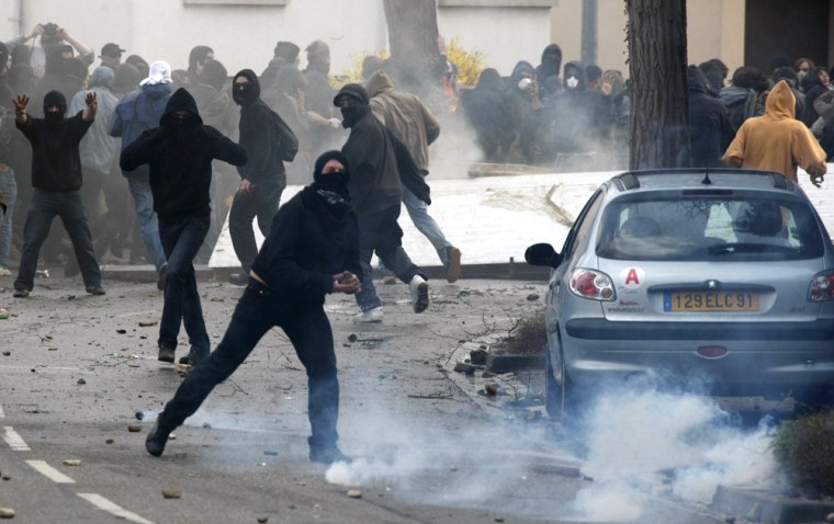 Image: Hooded anti-NATO demonstrators clash with French riot police
