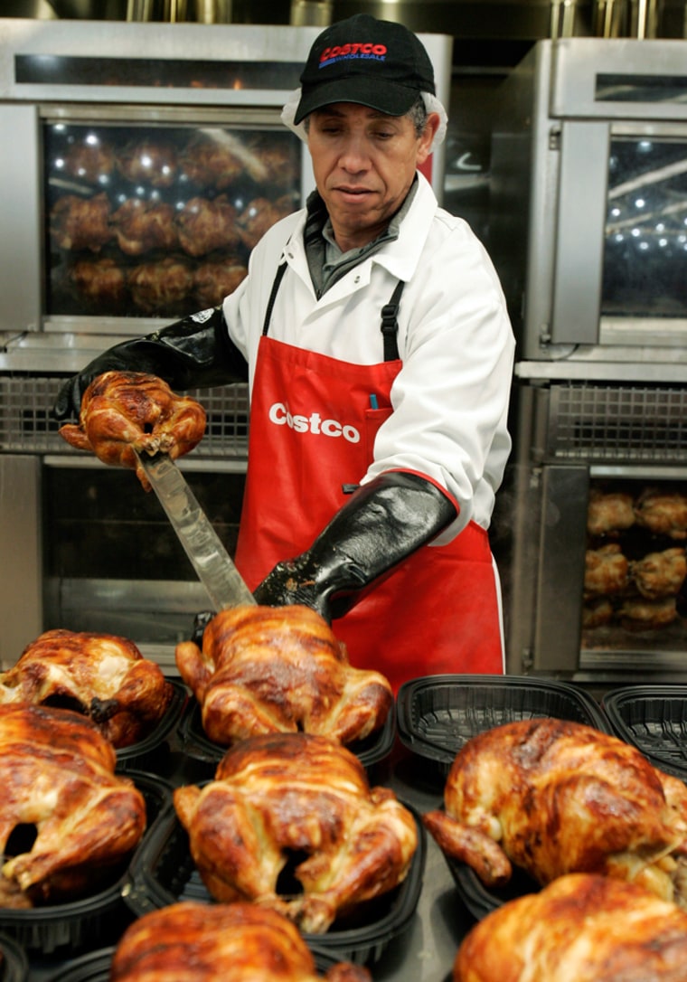 Image: A worker prepares chicken for sale at Costco in Mountain View store