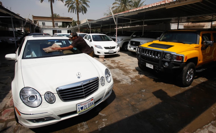 Image:  An Iraqi car dealer is seen at his automobile lot in Baghdad.