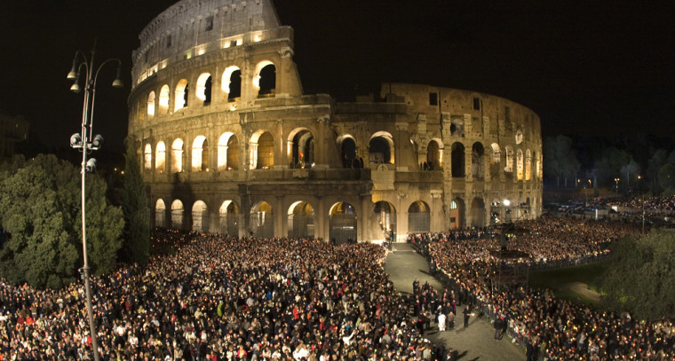 Image: The faithful attend the Via Crucis led by Pope Benedict XVI  at the Colosseum in Rome