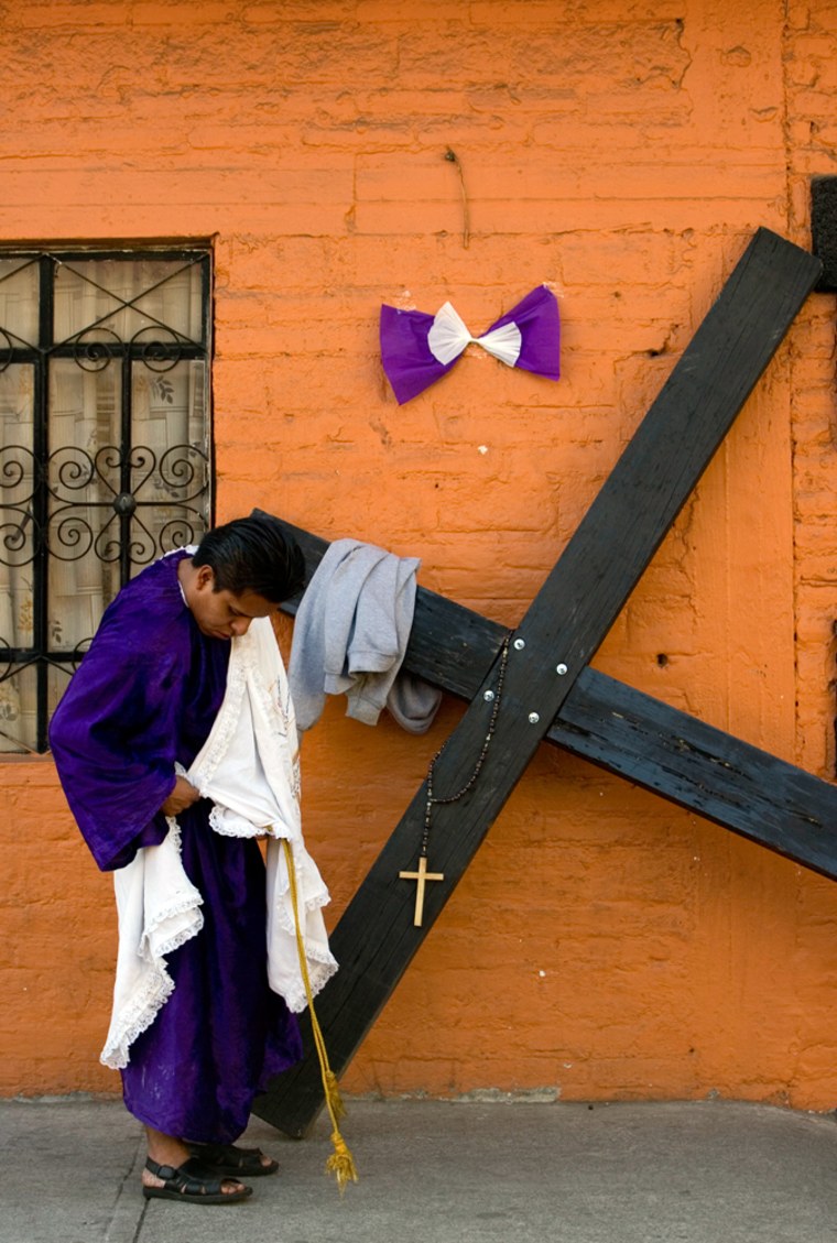 A man fixes his clothes in the neighborhood of Iztapalapa, in Mexico City, Friday, April 10, 2009. Every year hundreds of residents from this working-class neighborhood carry crosses up a nearby hill in one of Mexico's largest Holy Week celebrations. (AP Photo/Eduardo Verdugo)