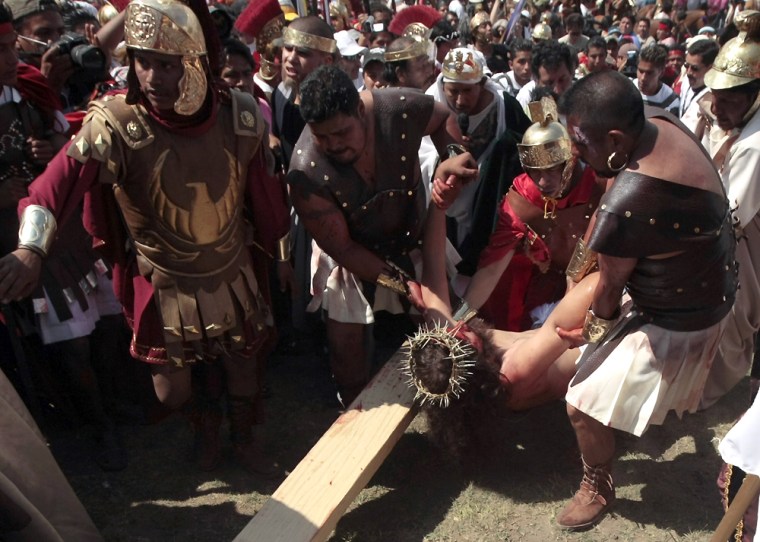 Diego Villagran, 18, is carried during a re-enactment of the crucifixion of Jesus Christ in Iztapalapa district