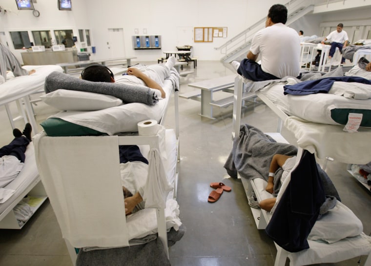 In this photo taken on Friday, Oct. 17, 2008, detainees are shown resting on bunks inside the \"B\" cell and bunk unit of the Northwest Detention Center in Tacoma, Wash. The facility is operated by The GEO Group Inc. under contract from U.S. Immigrations and Customs Enforcement, and houses people whose immigration status is in question or who are waiting for deportation or deportation hearings. (AP Photo/Ted S. Warren)