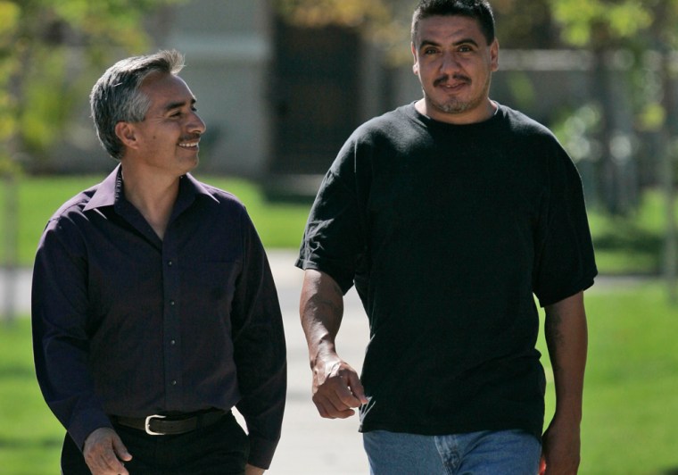 This photo taken on Tuesday, Oct. 7, 2008 shows Rene Saldivar, right, walking with his brother-in-law Aquiles Rojas in Ceres, Calif. (AP Photo/Rich Pedroncelli)