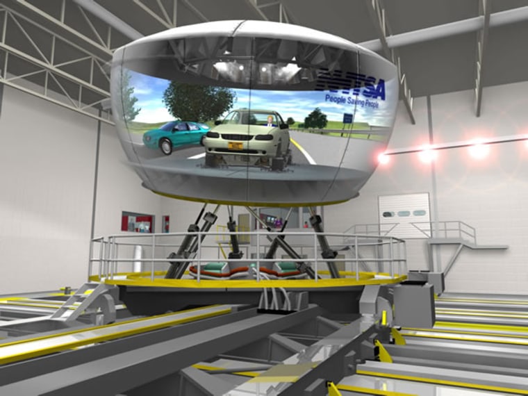 A computer-generated graphic shows the National Advanced Driving Simulator, with a cutaway view of a vehicle cab and projection screens inside.