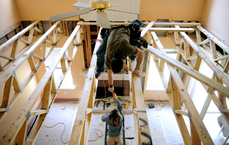 Mitch Castleberry, 34, works on making an additional room over what will be the den in the home he is sharing with his wife Teresa Bondora, 43, and her two children Ayla Bondora, 16, and Liam (pictured), 8. Castleberry and Bondora moved in with one of their friends in Kennesaw, Ga after walking away from their Atlanta home, leaving it to foreclose. Bondora and Castelberry live in the home with Bondora's two children Ayla Bondora, 16, and Liam (Teresa did not want his last name used), 8. Bondora shares a bedroom with her husband and her son because she says she wanted her teenage daughter to have her own room. In exchange for the 300 dollar a month rent to live in the home, the couple has agreed to do some renovation work on the home. Teresa also home schools both her children. ELISSA EUBANKS/SPECIAL