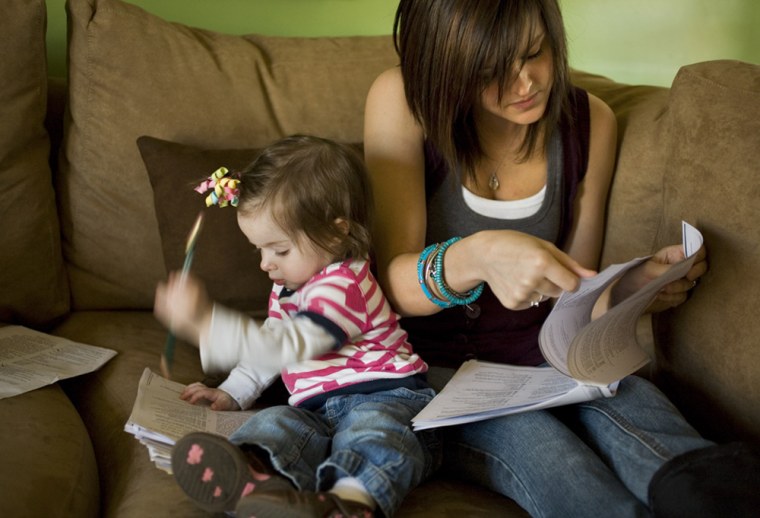 Ashley Van Wormer, 20, studies for a GED test in the company of her one-year-old daughter Payton in Elkhart, Indiana.