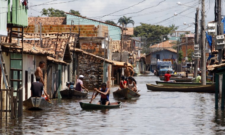 Boats transport people along streets flooded by Tocantins river in Maraba
