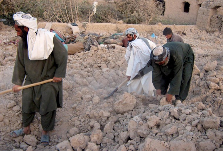 Image: Afghans search for their belongings amid rubble of their destroyed houses