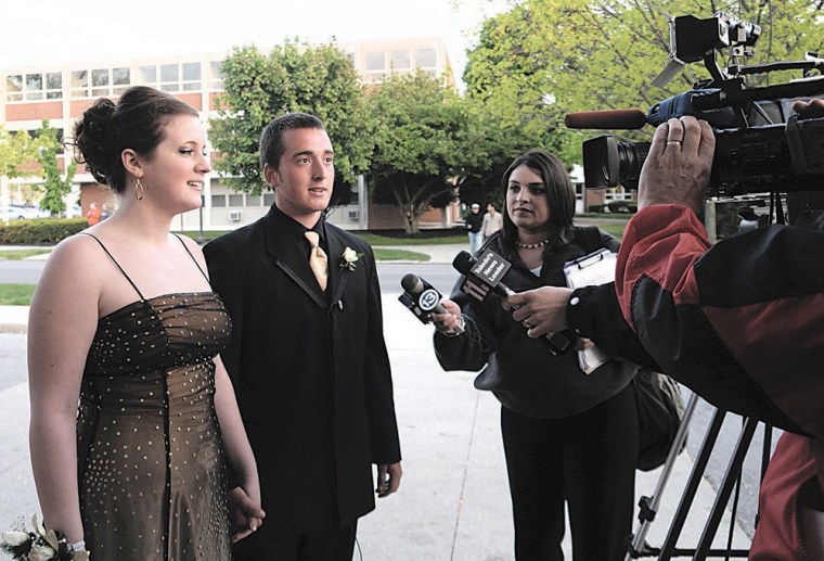 Tyler Frost and his prom date Rebecca Smooty are interviewed by local media outlets prior to attending Findlay High School's prom Saturday night.
