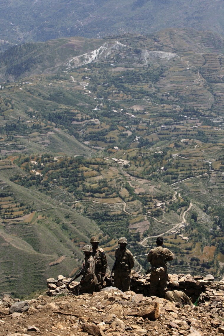 Image: Pakistani soldiers overlook the Swat valley from their bunker atop Baine Baba Ziarat mountain during a trip organized  by the Army
