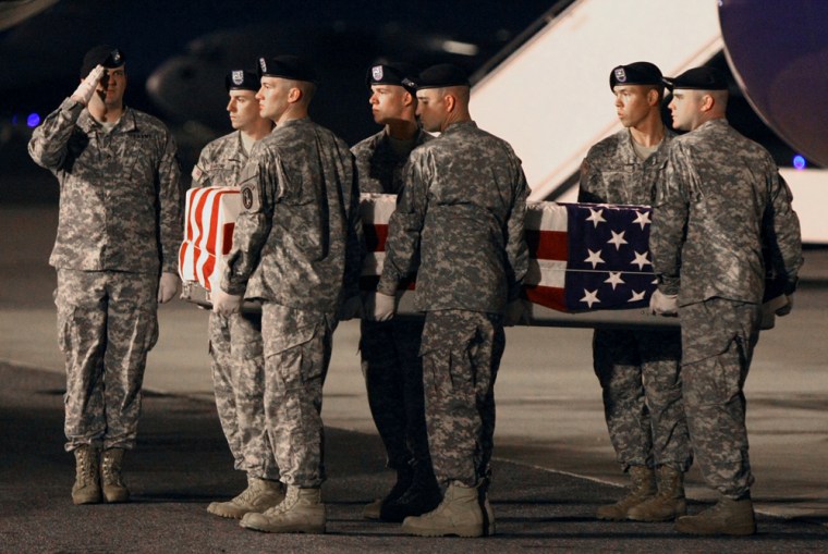 Image: An Army Corps carry team carries the transfer case containing the remains of a U.S. soldier at Dover Air Force Base.