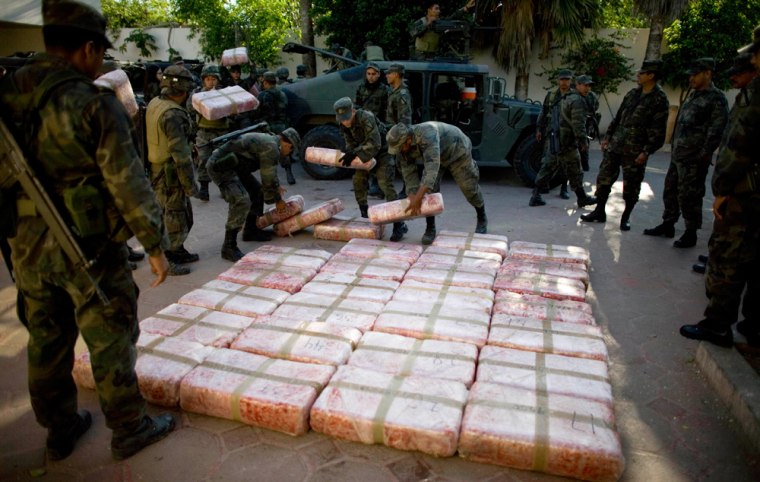 FILE - In this March 20, 2009 file photo,  Mexican soldiers place packages containing marijuana seized during an anti-drug operation at a military base in Guardados de Abajo, on Mexico's northeastern border with the United States. Mexico has deployed thousands of soldiers and federal agents to drug strongholds as part of a nationwide crackdown on drug cartels since President Felipe Calderon took office in 2006. (AP Photo/Alexandre Meneghini, File)