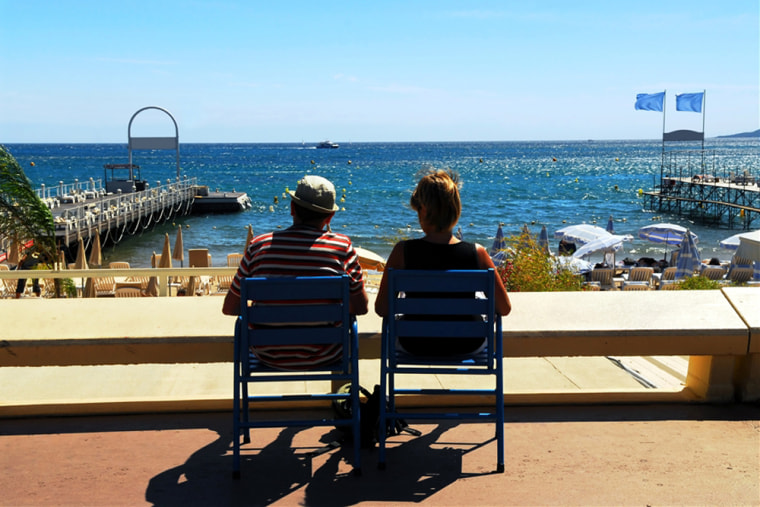 Image: Couple relaxing in charis on Croisette promenade in Cannes, France