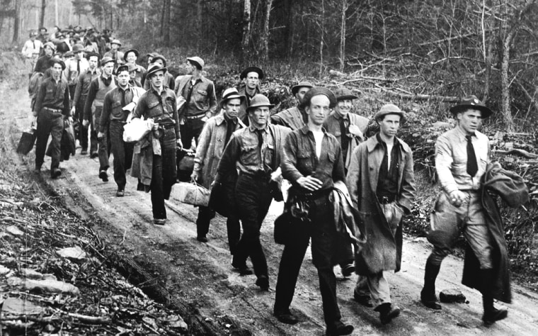 Civilian Conservation Corps recruits arrive to set up their first reforestation work camp near Powell's Fort, Virginia on April 18, 1933. The CCC was a New Deal-era massive environmental improvement program that recruited nearly 3 million young American men from 1933-1942. The men were paid $1/day.