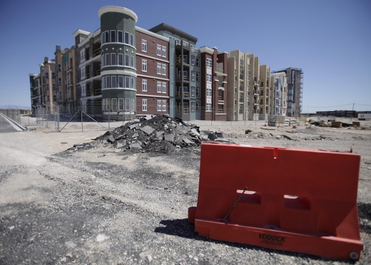 Image: Manhattan West, a stalled condominium project, stands unfinished behind a fence in Las Vegas.