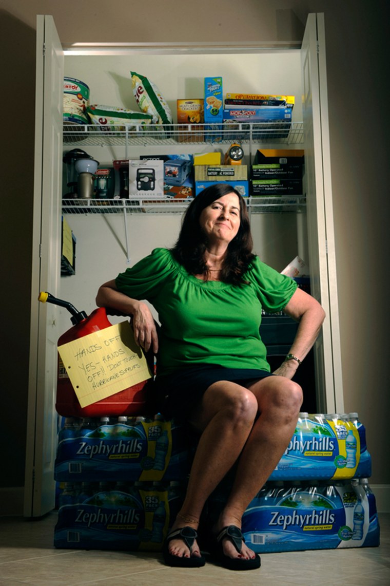 Image: Susan Scibetta of Boynton Beach, Fla., sits in front of all of the supplies in her hurricane closet