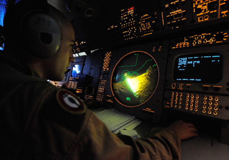Image: A crew member monitors instruments as a Breguet Atlantique flies a search mission