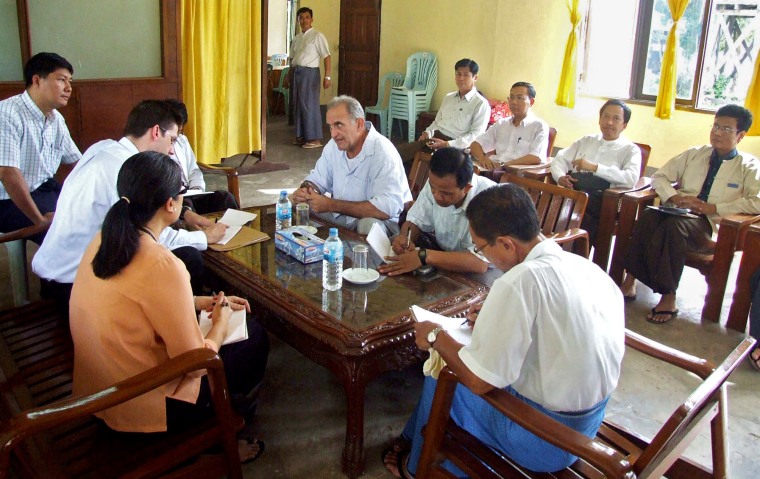 Image: US citizen John William Yettaw (3rd L on the table) talking to the second secretary consul of the US embassy Colin P. Sur